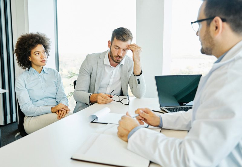 Couple-consulting-with-a-medical-professional-for-treatment