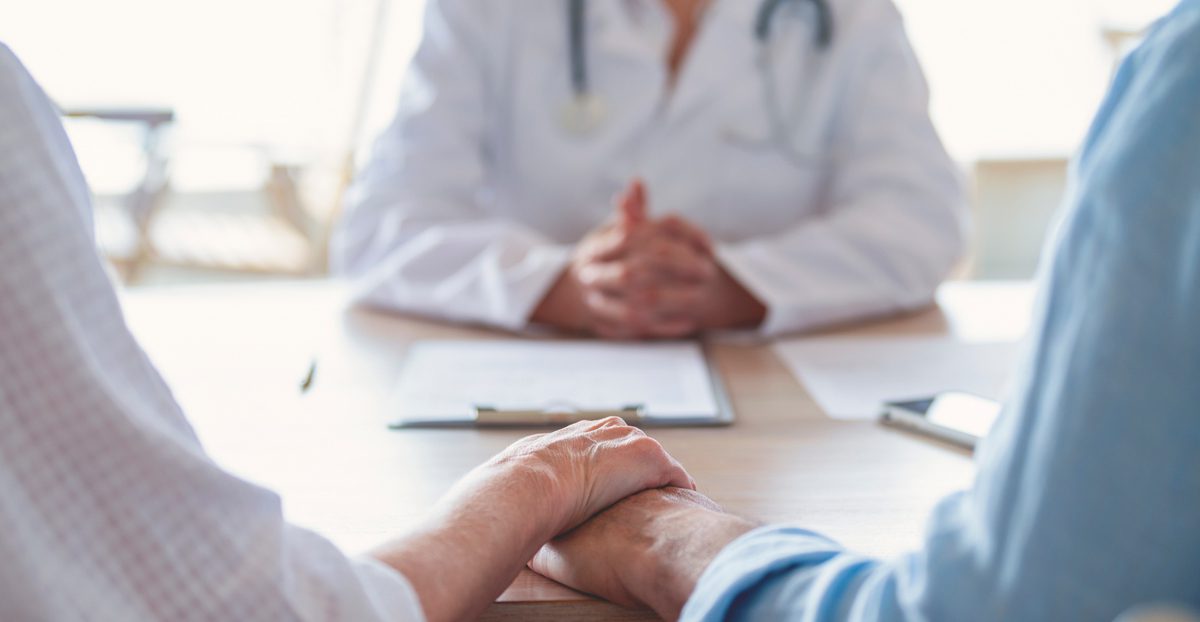 Couple-discussing-with-doctor-on-health-concerns