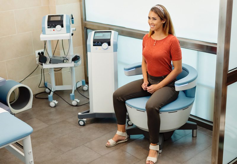 Happy-woman-during-electromagnetic-procedure