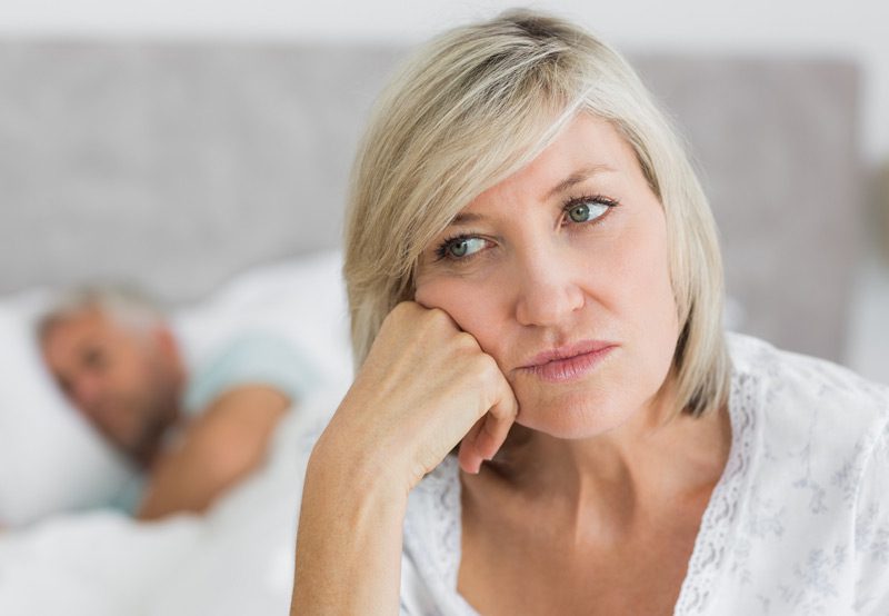 Mature-woman-sitting-in-bed