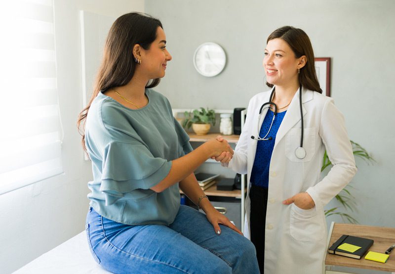 Smiling-doctor-with-patient Smiling-doctor-with-patient