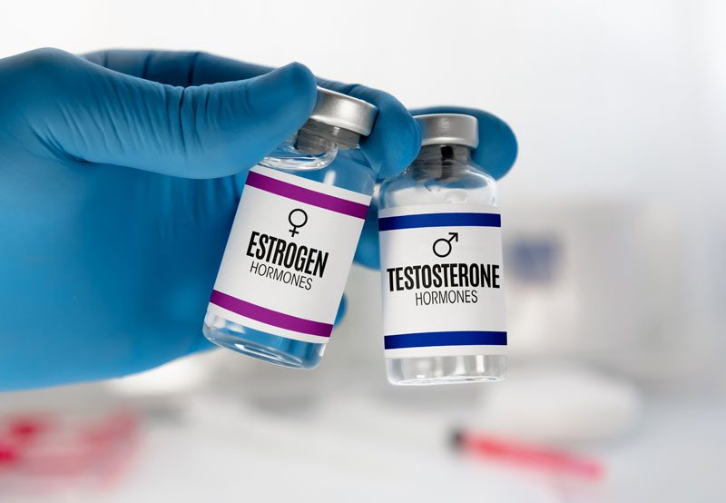 Doctor-with-bottles-for-testosterone-and-estrogen-hormonal-therapy